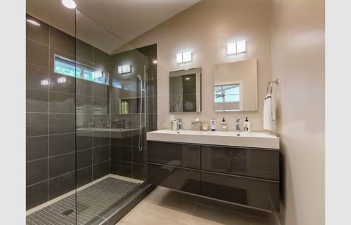 Master bathroom shower and floating cabinet. 