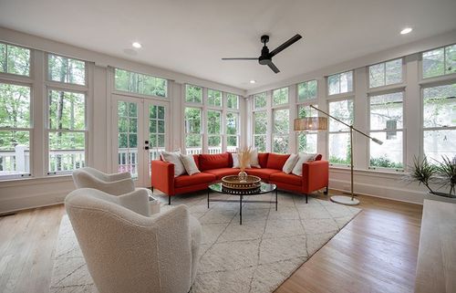 A gallery of windows allows natural light to flow around these gorgeous hardwood floors.