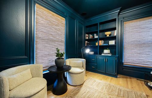 Custom built-in cabinetry painted a monochromatic dark blue-green to match the rest of the room. 