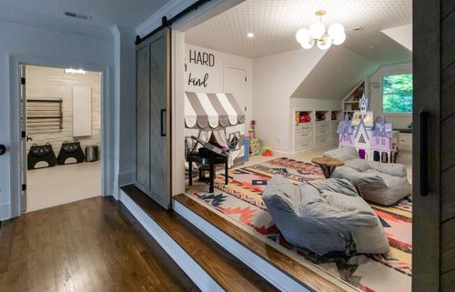 Playroom: Large double barn doors with herringbone pattern, custom cabinetry, custom in-wall desks, wallpaper