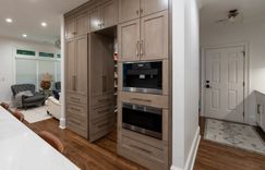 Kitchen: Custom cabinetry, quartzite countertops and backsplash, paneled appliances, hidden pantry, mudroom