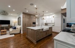 Kitchen: Custom cabinetry, quartzite countertops and backsplash, paneled appliances, hidden pantry, mudroom