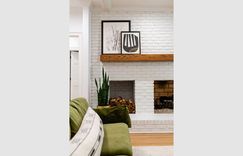 What’s not to love with a painted white fireplace and  wood mantel combo?